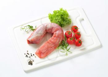 Raw pork tenderloin on cutting board