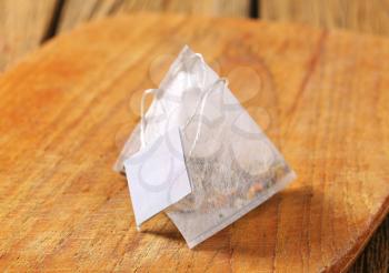 Pyramid-shaped tea bag on wood