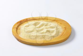 Finely ground bread crumbs on oval cutting board