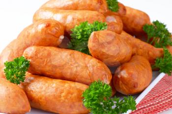 Pile of short kielbasa sausages on plate