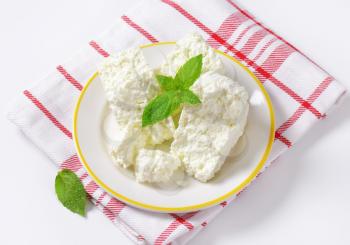 Crumbly white cheese on plate