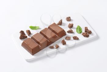chocolate bar on white cutting board