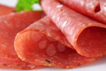 Thinly sliced salami infused with pieces of black truffles