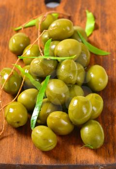 Fresh green olives on cutting board