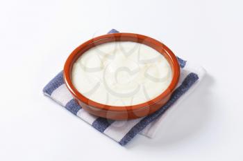 Smooth semolina porridge served in terracotta dish