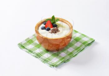 Smooth semolina porridge served with fresh fruit and grated chocolate