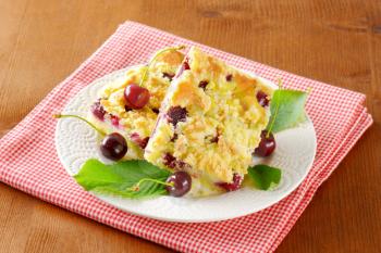 Sour cherry crumb bars on white plate