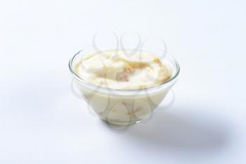 Bowl of fresh yoghurt with pieces of fruit