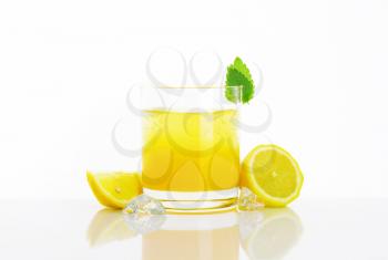 Glass of fresh lemon juice drink with ice