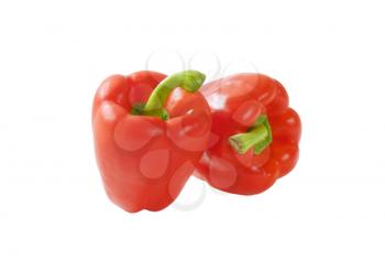 two red bell peppers isolated on white background
