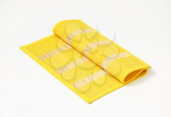 Yellow bamboo place mat with stripes