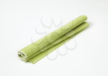 rolled up light green place mat