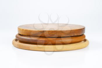 stack of three round wooden cutting boards