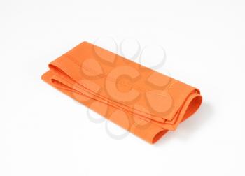 Orange napkin folded twice vertically