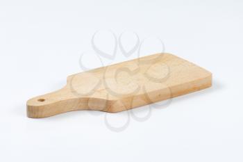 small wooden paddle cutting board