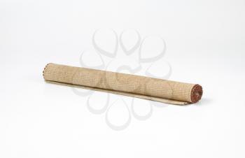 Rolled cotton placemat on white background