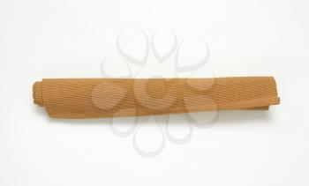 Rolled brown woven cotton place mat