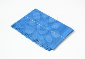 Blue woven cotton placemat folded twice