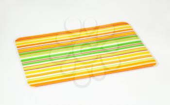 Laminated brightly colored striped table mat
