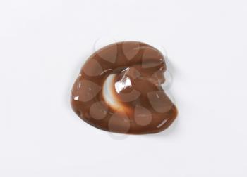 blob of chocolate pudding on white background