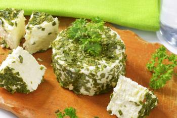 fresh cheese coated in chives and garlic