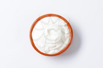 white yogurt or sour cream in a ceramic bowl