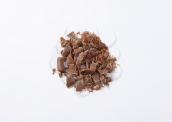 heap of chocolate pieces on white background