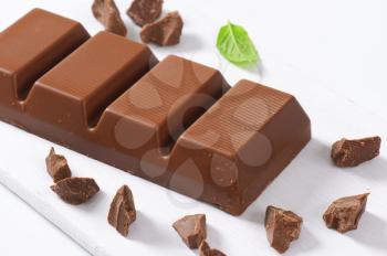 chocolate bar on white cutting board