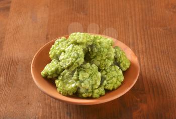 bowl of wasabi crackers on wooden table