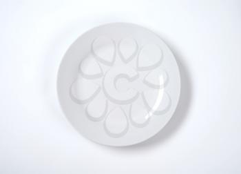 empty white plate on off-white background