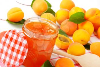 Jar of apricot jam and fresh apricots