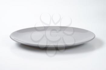 empty grey dinner plate without rim