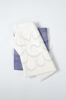 two folded cloth napkins or place mats