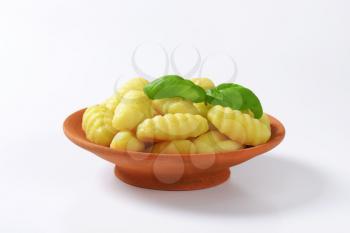 Cooked potato gnocchi in terracotta dish