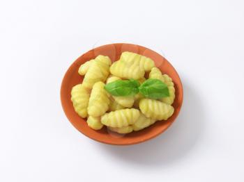 Cooked potato gnocchi in terracotta dish