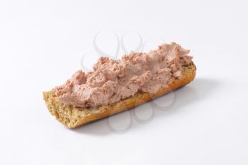 Baguette roll with pate on white background