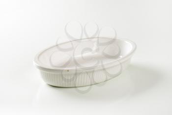 Empty deep oval porcelain baking dish