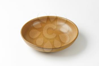 Empty brown ceramic serving bowl