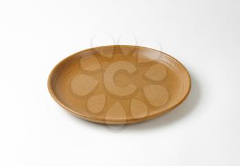 Round brown ceramic dinner plate