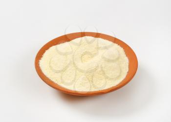Heap of semolina flour on a ceramic plate