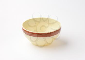 beige cereal bowl with brown band on the outside