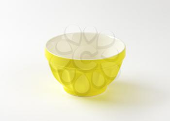 Empty yellow stoneware mixing bowl