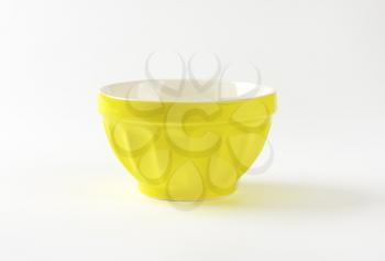 Empty yellow stoneware mixing bowl