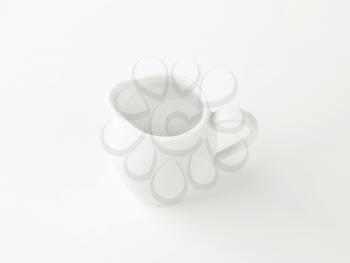 empty white porcelain cream jug