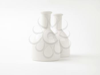 two white vases on white background