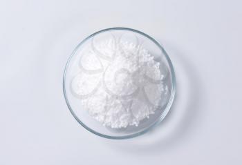 Heap of edible salt on small glass plate