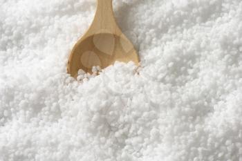 Detail of coarse grained salt and wooden spoon