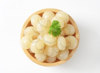 bowl of pickled onions on white background
