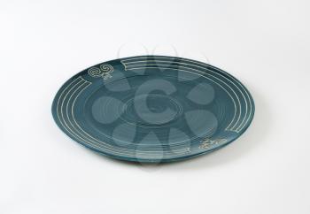 Handcrafted ceramic plate with engraved symbols