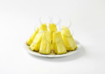 Fresh pineapple wedges on plate